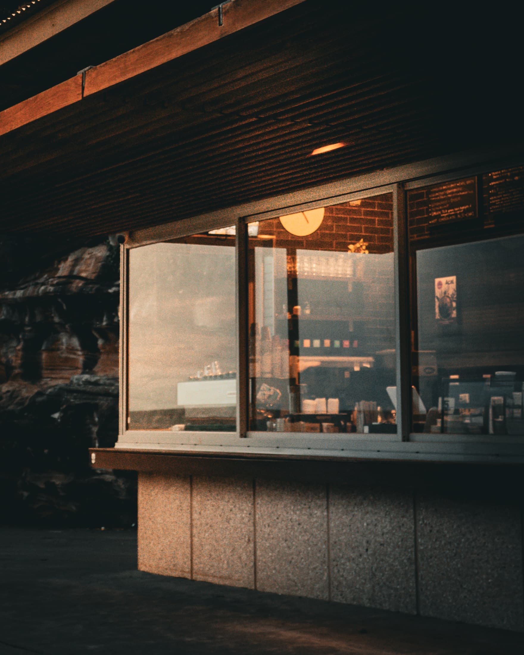 Corner shop window beneath an overpass