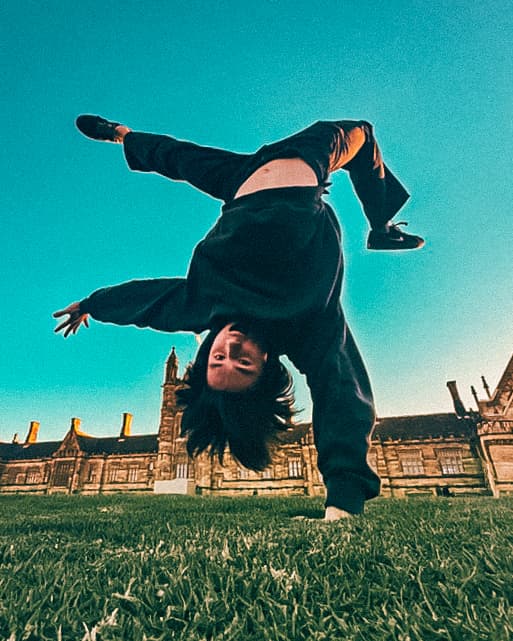 Josh Hatchard doing a handstand on grass